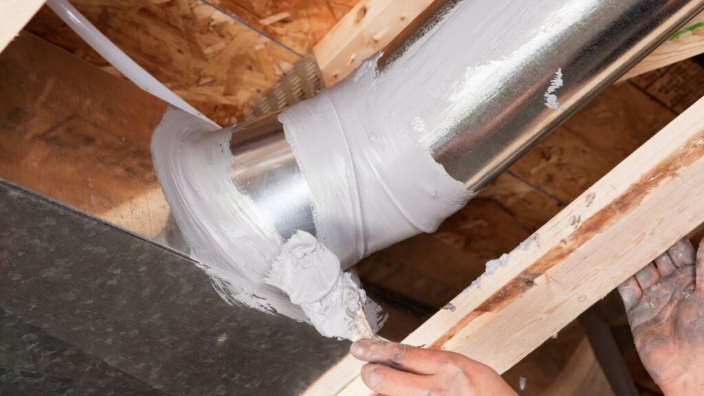 a man sealing an air duct joint pipes in hampton roads