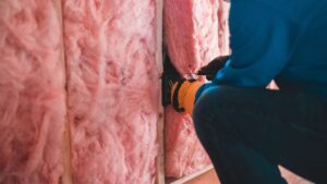contractor installing insulation on walls