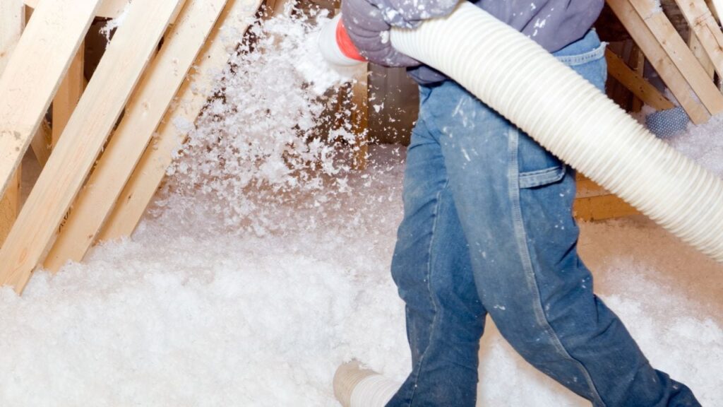 contractor using a blown insulation