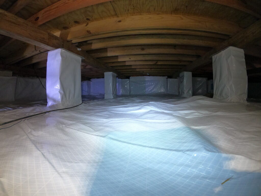 A room with a tarp covering the floor, indicating that insulation issues require immediate attention.